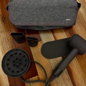 Dyson Supersonic Hair Dryer with attachments and case.